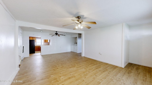 1117 6th St, Carrollton, KY 41008 - unfurnished living room with ceiling fan, washing machine and dryer, and light wood-style floors