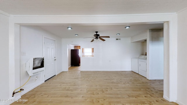 1117 6th St, Carrollton, KY 41008 - unfurnished living room with heating unit, light wood-style floors, a ceiling fan, washing machine and clothes dryer, and recessed lighting