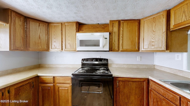 1117 6th St, Carrollton, KY 41008 - kitchen featuring white microwave, black / electric stove, light countertops, a textured ceiling, and brown cabinets