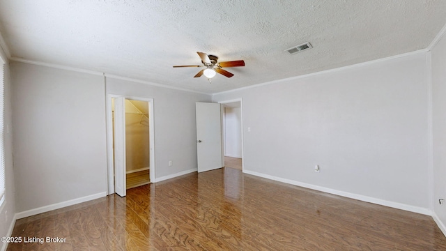 1117 6th St, Carrollton, KY 41008 - unfurnished bedroom featuring wood finished floors, crown molding, a textured ceiling, ceiling fan, and a spacious closet