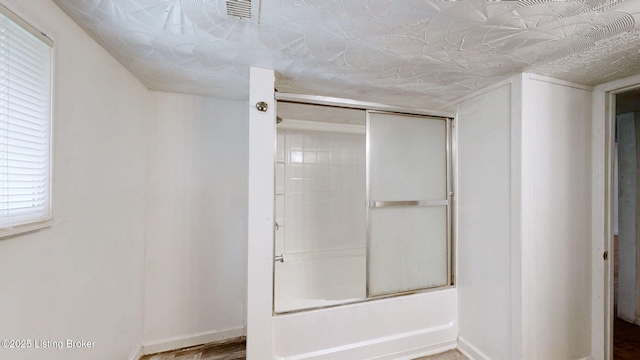 1117 6th St, Carrollton, KY 41008 - full bath with enclosed tub / shower combo and wood finished floors