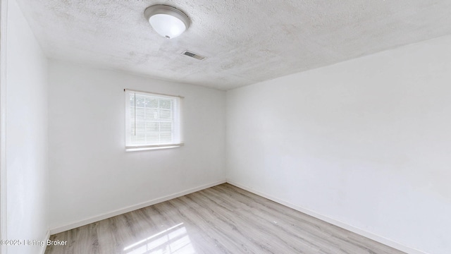 1117 6th St, Carrollton, KY 41008 - empty room with wood finished floors and a textured ceiling