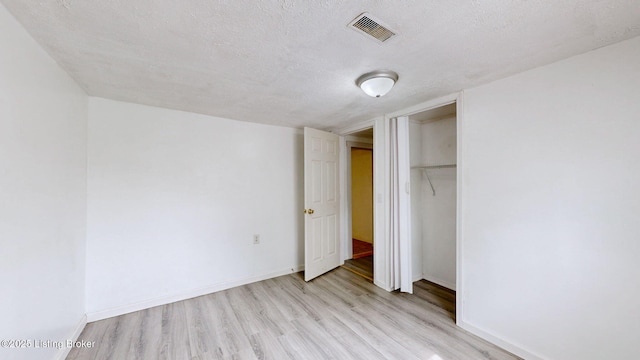 1117 6th St, Carrollton, KY 41008 - unfurnished bedroom featuring light wood finished floors, a textured ceiling, and a closet