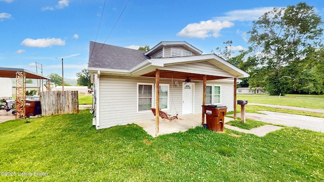 1117 6th St, Carrollton, KY 41008 - bungalow-style home with a shingled roof, a front yard, and a patio area