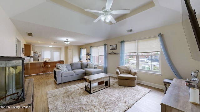 7236 Michael Benjamin Cir, Crestwood, KY 40014 - living room featuring light wood-style floors, ceiling fan, and a tray ceiling