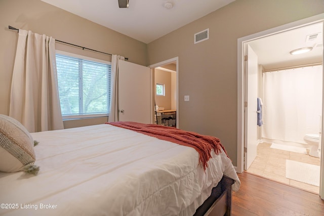 2745 Grinstead Dr Apt 113, Louisville, KY 40206 - bedroom with wood finished floors and ensuite bathroom