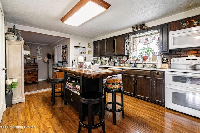 607 Hardin Springs Rd, Big Clifty, KY 42712 - kitchen featuring white appliances, a textured ceiling, light countertops, dark brown cabinetry, and wood-type flooring