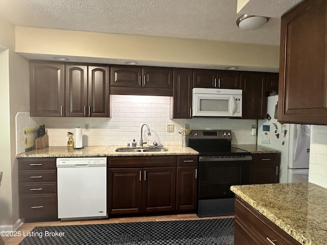 509 Piping Rock Rd, Brandenburg, KY 40108 - kitchen featuring white appliances, dark brown cabinetry, backsplash, light stone countertops, and a textured ceiling