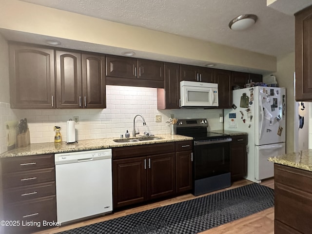 509 Piping Rock Rd, Brandenburg, KY 40108 - kitchen featuring white appliances, dark brown cabinets, backsplash, light wood-type flooring, and light stone counters