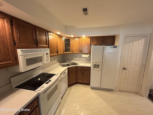 4125 Browns Ln Unit 117, Louisville, KY 40220 - kitchen with white appliances, light countertops, and glass insert cabinets