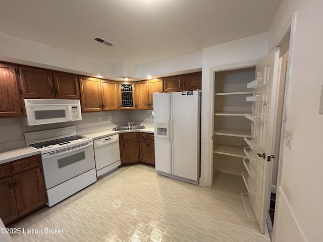 4125 Browns Ln Unit 117, Louisville, KY 40220 - kitchen featuring white appliances, light countertops, and brown cabinets