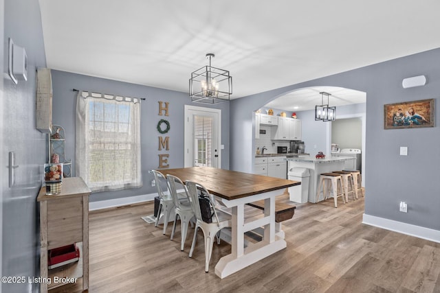 63 Davis Norton Ln, Harned, KY 40144 - dining area with a chandelier, light wood-type flooring, and arched walkways