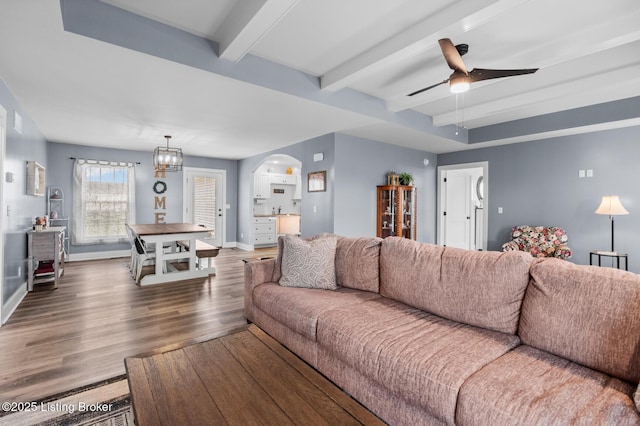 63 Davis Norton Ln, Harned, KY 40144 - living room featuring wood finished floors, arched walkways, beam ceiling, a ceiling fan, and a chandelier