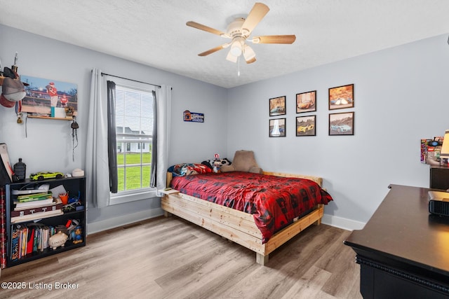 63 Davis Norton Ln, Harned, KY 40144 - bedroom with wood finished floors, ceiling fan, and a textured ceiling