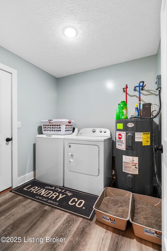 63 Davis Norton Ln, Harned, KY 40144 - laundry area featuring electric water heater, independent washer and dryer, wood finished floors, and a textured ceiling