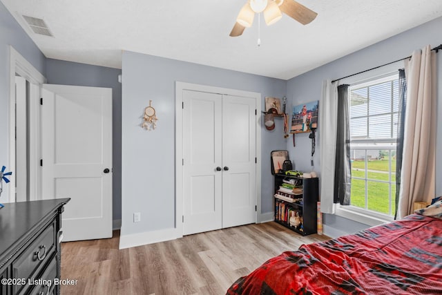 63 Davis Norton Ln, Harned, KY 40144 - bedroom with light wood finished floors, multiple windows, a closet, and ceiling fan