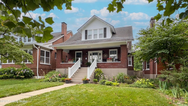 1910 Alfresco Pl, Louisville, KY 40205 - bungalow-style home with brick siding, a front lawn, a porch, and stairs
