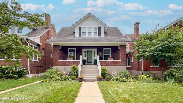 1910 Alfresco Pl, Louisville, KY 40205 - bungalow-style home featuring brick siding, covered porch, a front lawn, stairway, and a chimney