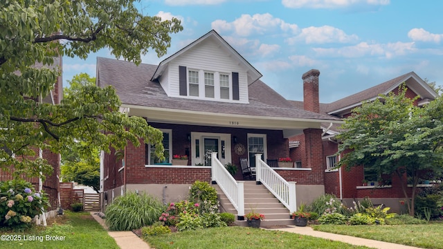 1910 Alfresco Pl, Louisville, KY 40205 - bungalow-style home with stairs, brick siding, a porch, a shingled roof, and a chimney
