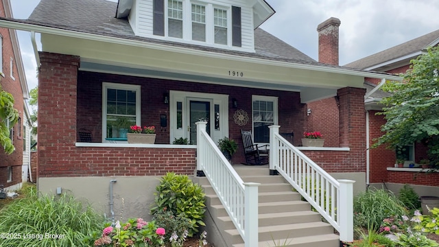 1910 Alfresco Pl, Louisville, KY 40205 - property entrance featuring brick siding, a porch, and a shingled roof