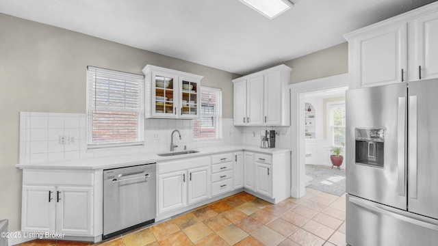 1910 Alfresco Pl, Louisville, KY 40205 - kitchen with appliances with stainless steel finishes, backsplash, white cabinets, light countertops, and glass insert cabinets