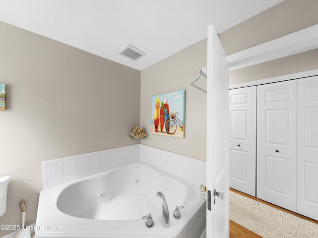 1910 Alfresco Pl, Louisville, KY 40205 - bathroom featuring a tub with jets and wood finished floors