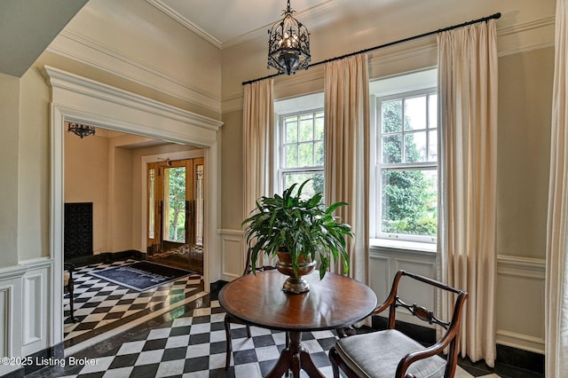 1416 Willow Ave Unit 3B, Louisville, KY 40204 - dining space with inlaid floor details, a decorative wall, a chandelier, a wainscoted wall, and ornamental molding