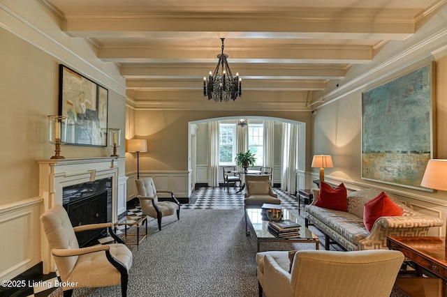 1416 Willow Ave Unit 3B, Louisville, KY 40204 - living area with a decorative wall, arched walkways, beamed ceiling, a chandelier, and crown molding
