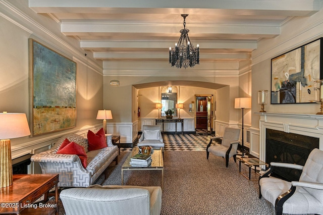 1416 Willow Ave Unit 3B, Louisville, KY 40204 - living room featuring a decorative wall, beam ceiling, a glass covered fireplace, arched walkways, and crown molding