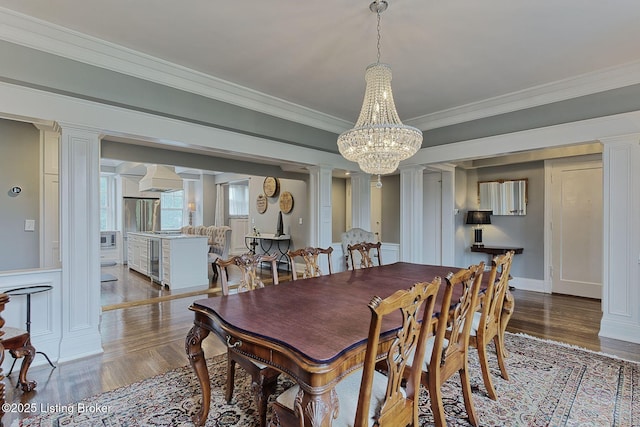 1416 Willow Ave Unit 3B, Louisville, KY 40204 - dining room with ornate columns, crown molding, wood finished floors, a chandelier, and beverage cooler