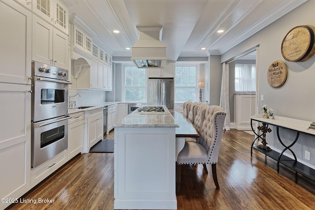 1416 Willow Ave Unit 3B, Louisville, KY 40204 - kitchen featuring stainless steel appliances, healthy amount of natural light, a kitchen breakfast bar, a kitchen island, and ornamental molding