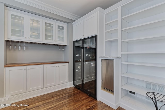 1416 Willow Ave Unit 3B, Louisville, KY 40204 - kitchen featuring wine cooler, dark wood-style flooring, white cabinetry, ornamental molding, and glass insert cabinets