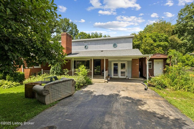 363 S Deepwood Dr, Radcliff, KY 40160 - traditional home featuring french doors, a chimney, and brick siding