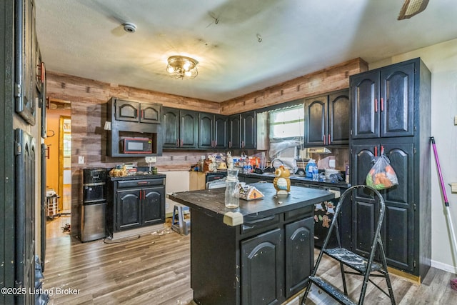 363 S Deepwood Dr, Radcliff, KY 40160 - kitchen with light wood-type flooring, dark countertops, and a center island