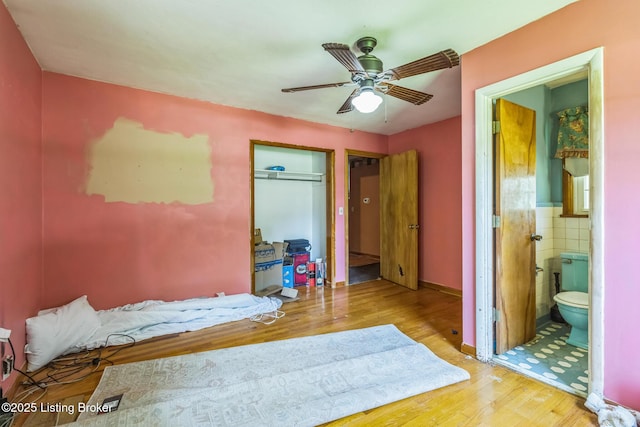 363 S Deepwood Dr, Radcliff, KY 40160 - bedroom with wood finished floors, a closet, tile walls, and ensuite bathroom