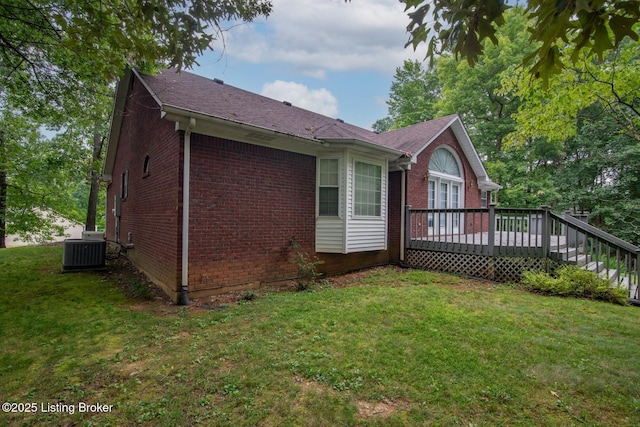 236 Bobwhite Rd, Brandenburg, KY 40108 - view of side of home with brick siding, a wooden deck, a lawn, and a shingled roof
