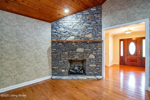 236 Bobwhite Rd, Brandenburg, KY 40108 - unfurnished living room with wood finished floors, ornamental molding, vaulted ceiling, wooden ceiling, and a stone fireplace