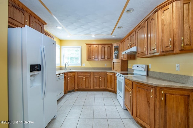 236 Bobwhite Rd, Brandenburg, KY 40108 - kitchen featuring white appliances, under cabinet range hood, brown cabinetry, light tile patterned flooring, and recessed lighting