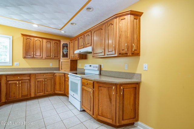 236 Bobwhite Rd, Brandenburg, KY 40108 - kitchen with white electric range, under cabinet range hood, brown cabinets, light tile patterned floors, and light countertops