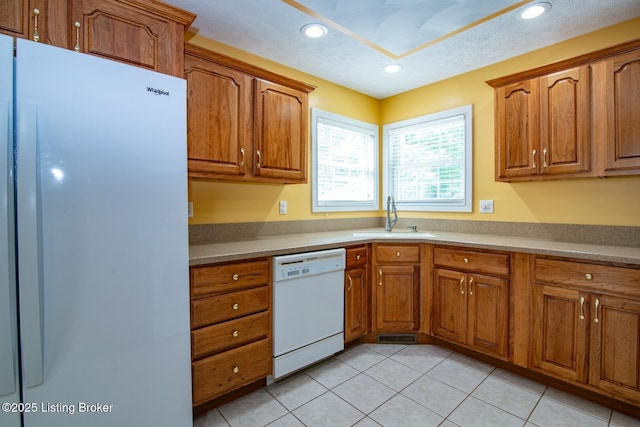 236 Bobwhite Rd, Brandenburg, KY 40108 - kitchen with white appliances, brown cabinetry, light tile patterned floors, and recessed lighting