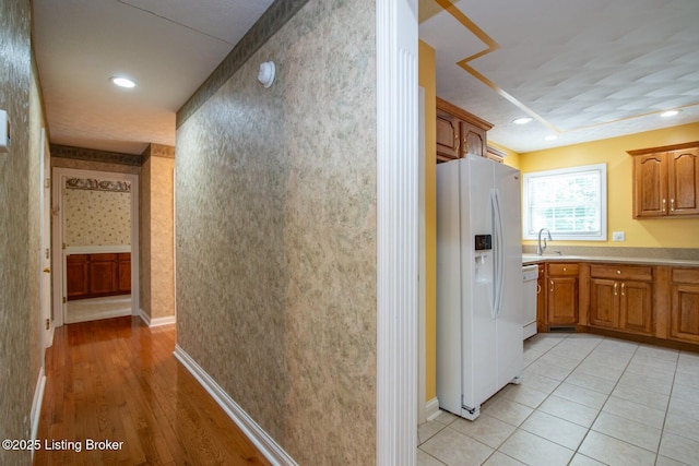 236 Bobwhite Rd, Brandenburg, KY 40108 - kitchen featuring white appliances, brown cabinetry, light countertops, light wood-style floors, and recessed lighting