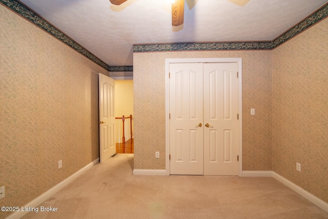 236 Bobwhite Rd, Brandenburg, KY 40108 - unfurnished bedroom featuring carpet flooring, a closet, a textured ceiling, and a ceiling fan