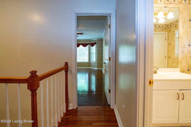 236 Bobwhite Rd, Brandenburg, KY 40108 - hall with dark wood-type flooring, wallpapered walls, and a chandelier