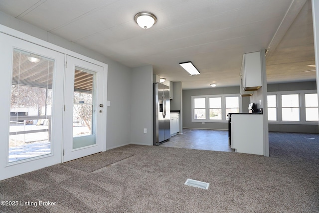 43 Mcfarlin Ln, Vine Grove, KY 40175 - kitchen with stainless steel fridge, carpet floors, open floor plan, dark countertops, and white cabinets