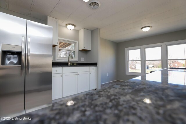 43 Mcfarlin Ln, Vine Grove, KY 40175 - kitchen with stainless steel fridge with ice dispenser, white cabinets, and dark stone countertops