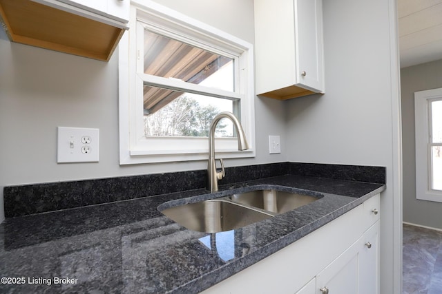 43 Mcfarlin Ln, Vine Grove, KY 40175 - kitchen featuring plenty of natural light, white cabinetry, and dark stone counters