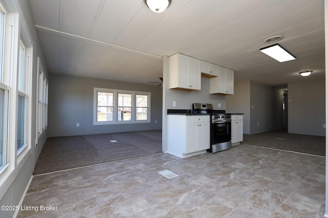 43 Mcfarlin Ln, Vine Grove, KY 40175 - kitchen with stainless steel range oven, dark countertops, open floor plan, and white cabinetry