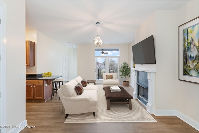 2011 Frankfort Ave Unit Unit312, Louisville, KY 40206 - living area featuring wood finished floors, a fireplace, and ceiling fan