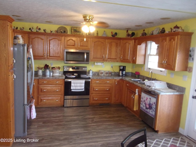 1366 Greens Chapel Rd, Bloomfield, KY 40008 - kitchen with stainless steel appliances, a ceiling fan, brown cabinetry, and dark wood finished floors