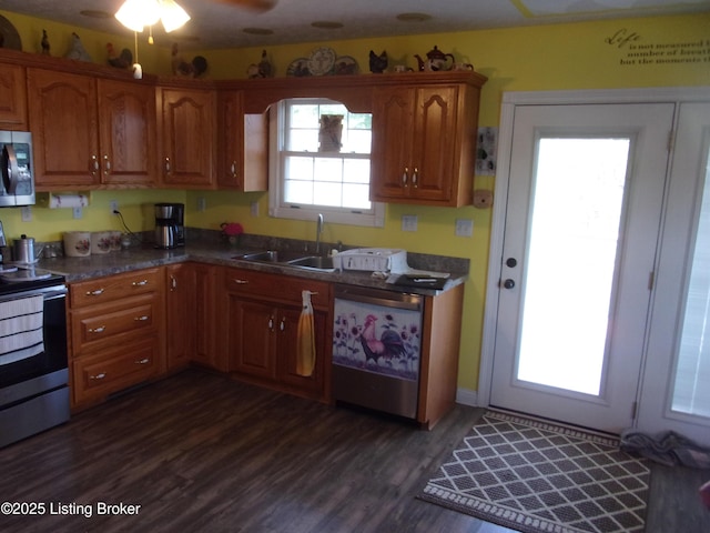 1366 Greens Chapel Rd, Bloomfield, KY 40008 - kitchen featuring stainless steel appliances, brown cabinetry, dark countertops, and dark wood-type flooring